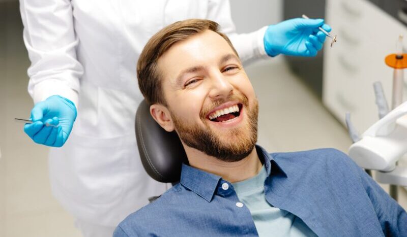 Happy patient smiling confidently after dental implant treatment at Natural Clinic, Istanbul.