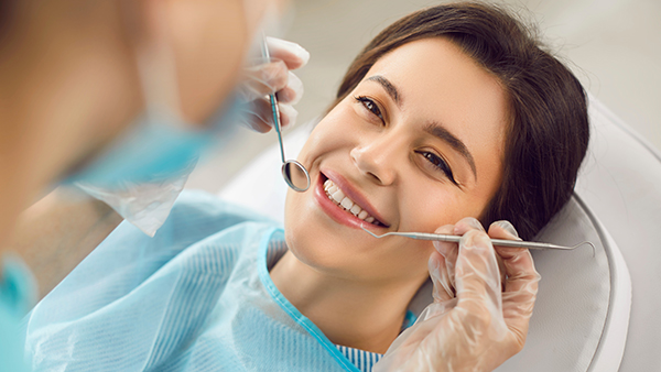 Smiling female patient during a dental check-up at a modern clinic.