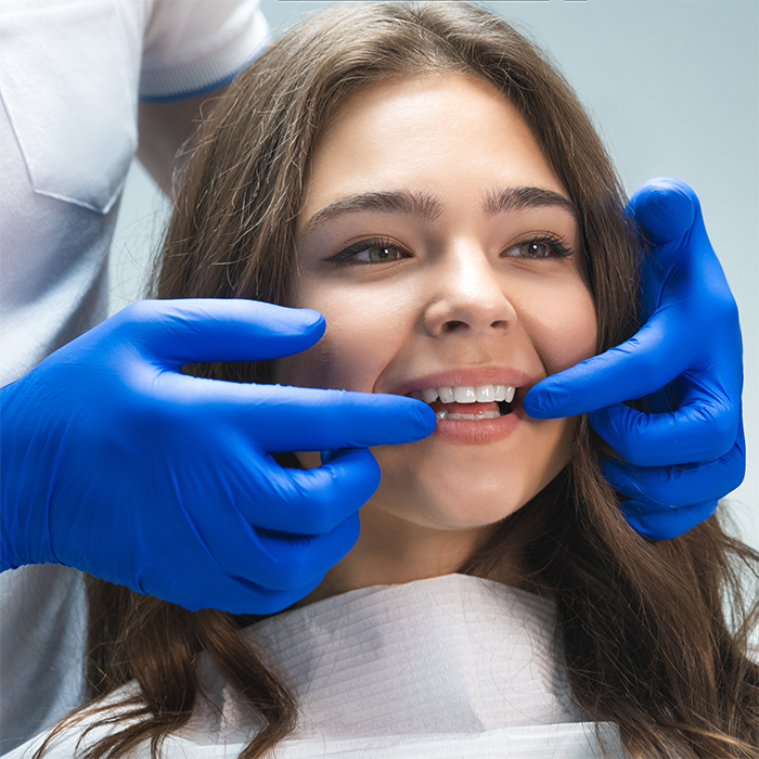 Dentist examines tooth alignment before dental crown placement
